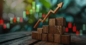 Upward arrow on wooden blocks with stock candles in background, symbolizing financial growth and progress.