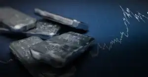 Silver bullion bars on a financial chart background.